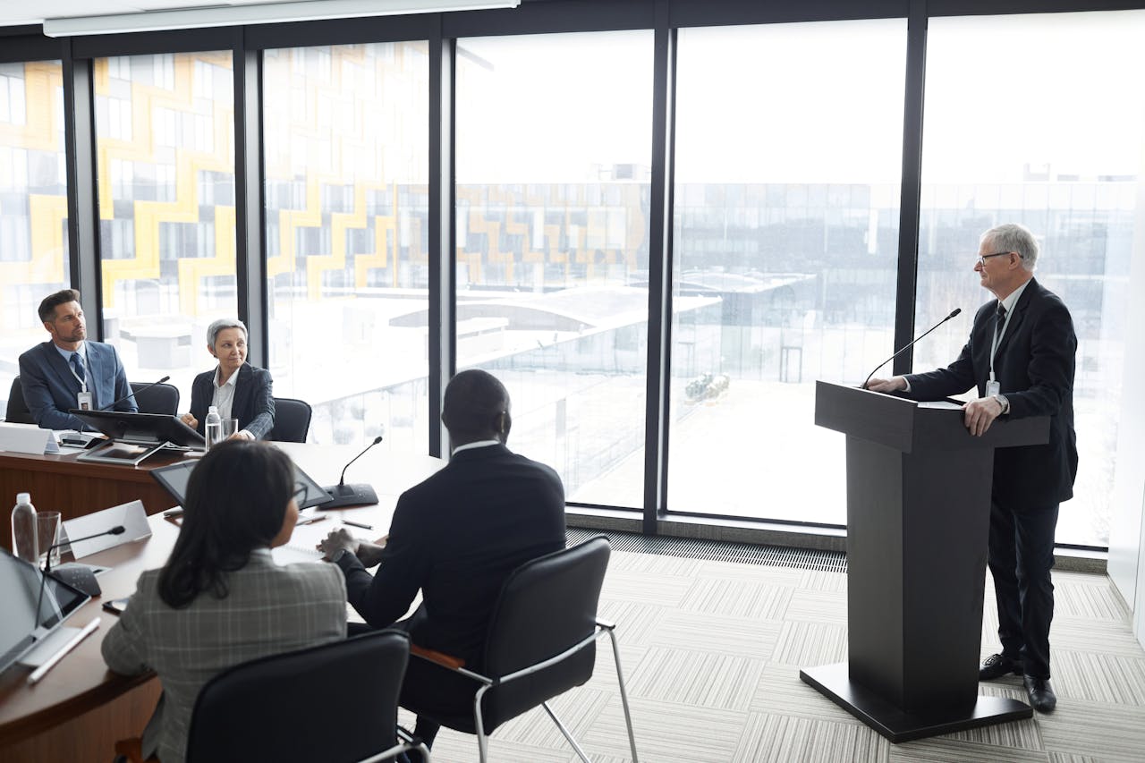 Crafting Captivating Headlines: Your awesome post title goes here Corporate professionals engaged in a formal business meeting in a modern conference room setting.
